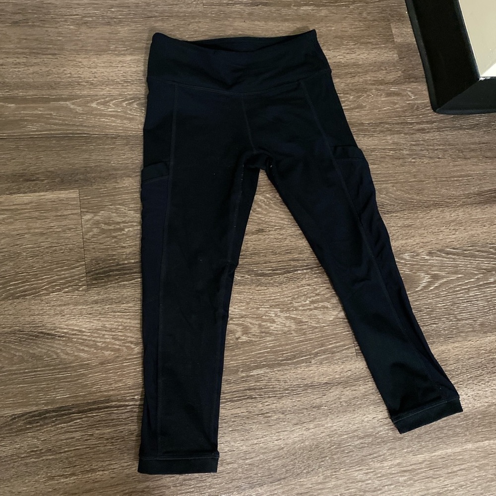 Fabletics black cropped leggings with side pockets.